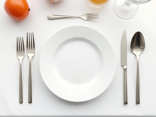 Assortment of elegant crockery, cutlery, and glassware arranged for an event